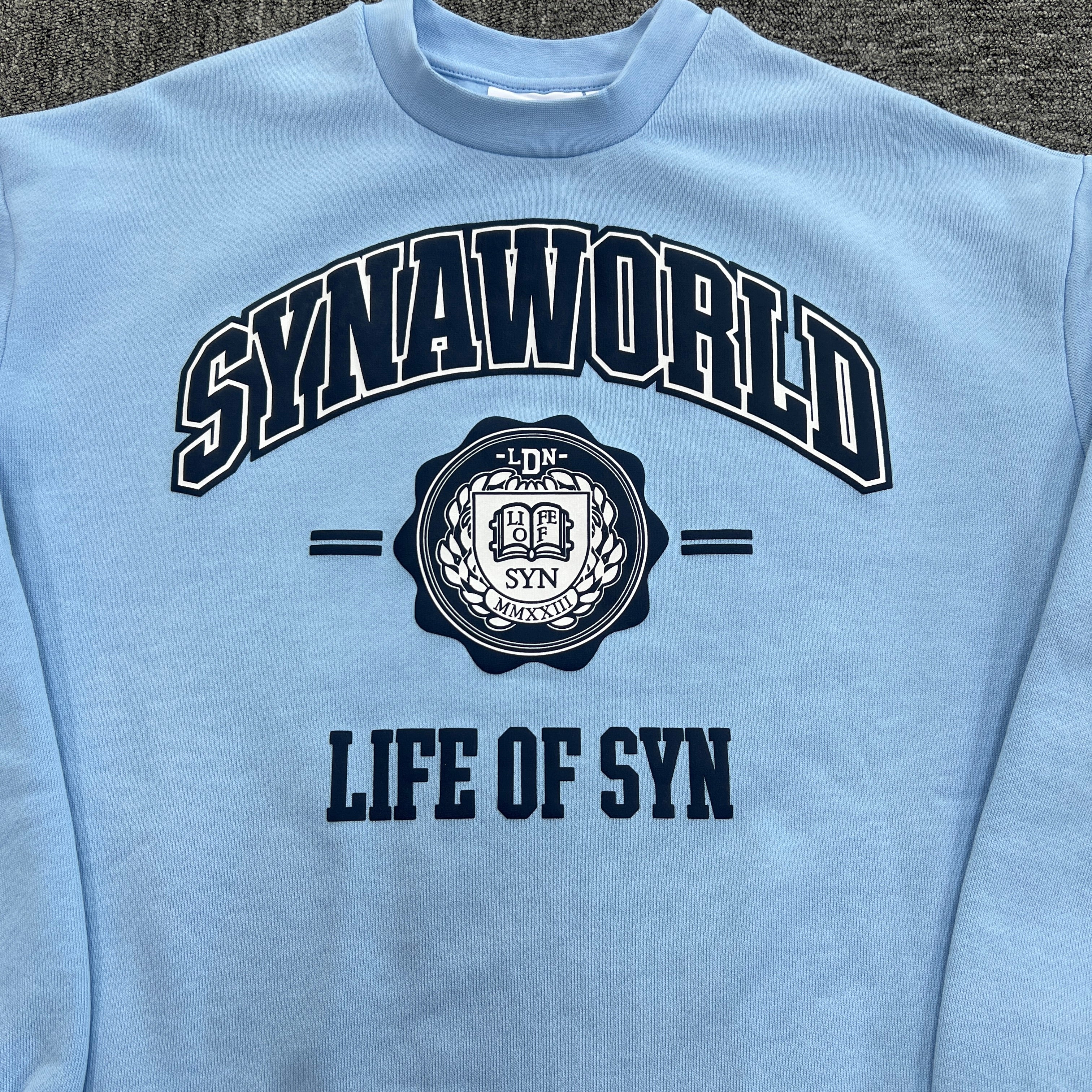 SYNA LONG SLEEVE VARSITY CREW SWEAT- BABY BLUE